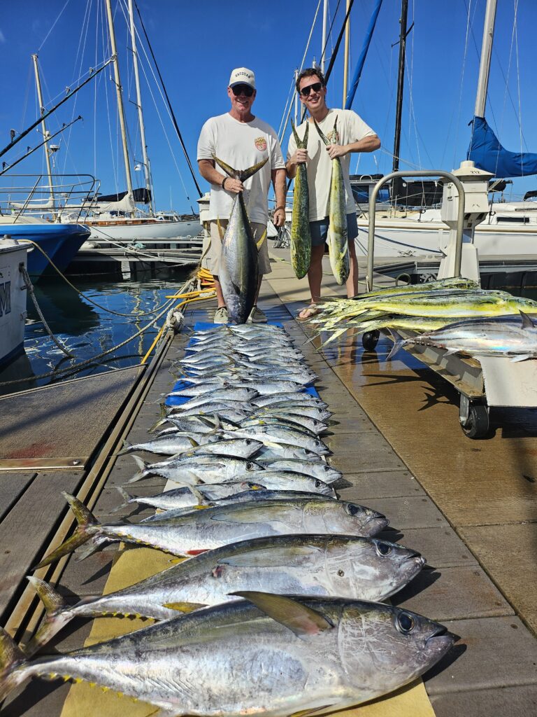 Two men proudly display a large catch of fish on a dock by the marina.